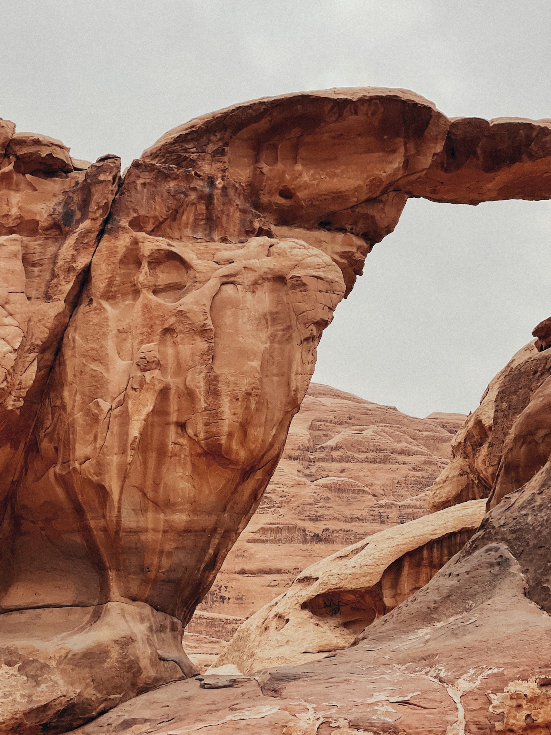 Sandstone rock formation rising above the desert in Wadi Rum.