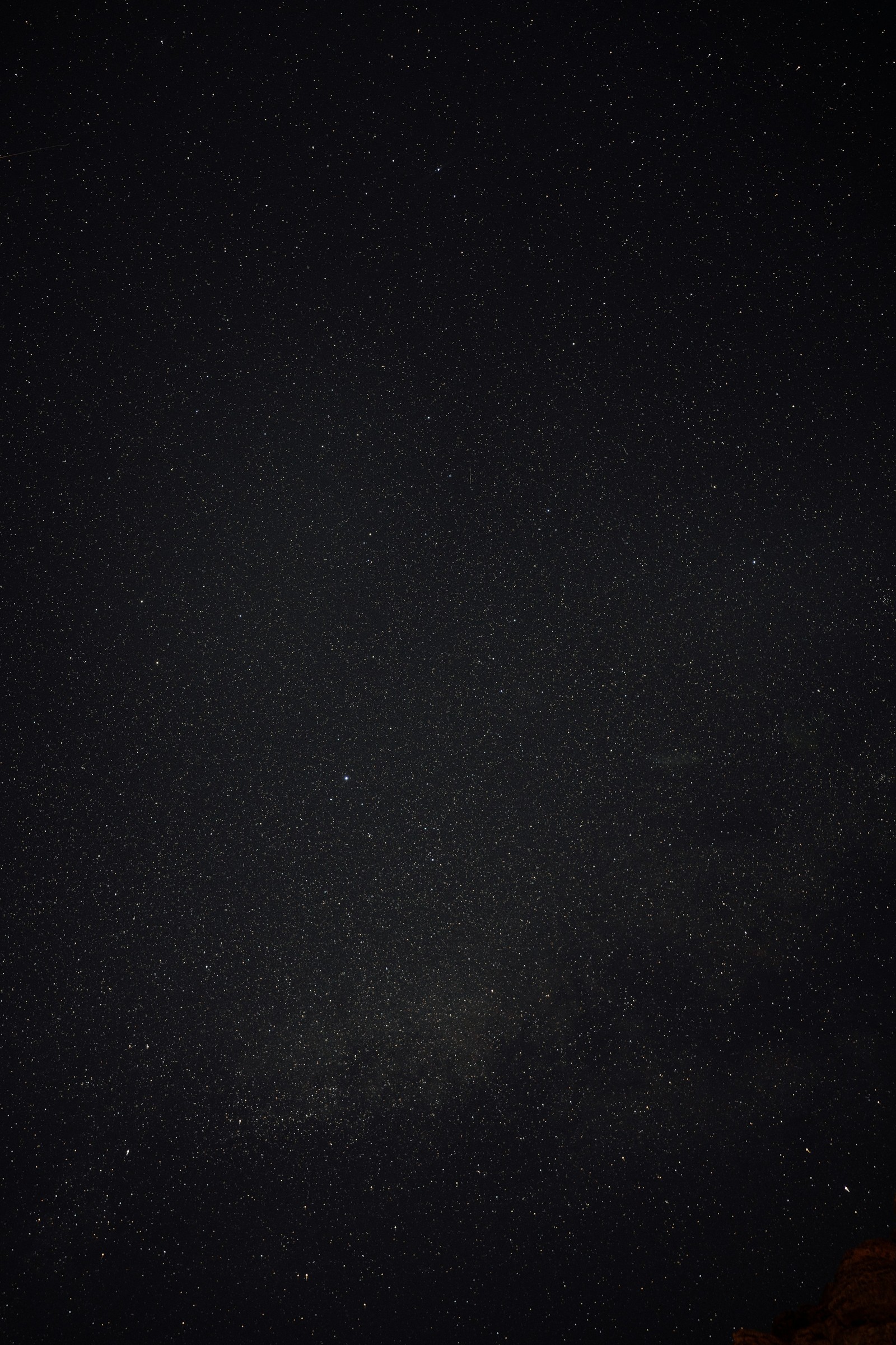 Stars above the dark desert landscape of Wadi Rum.