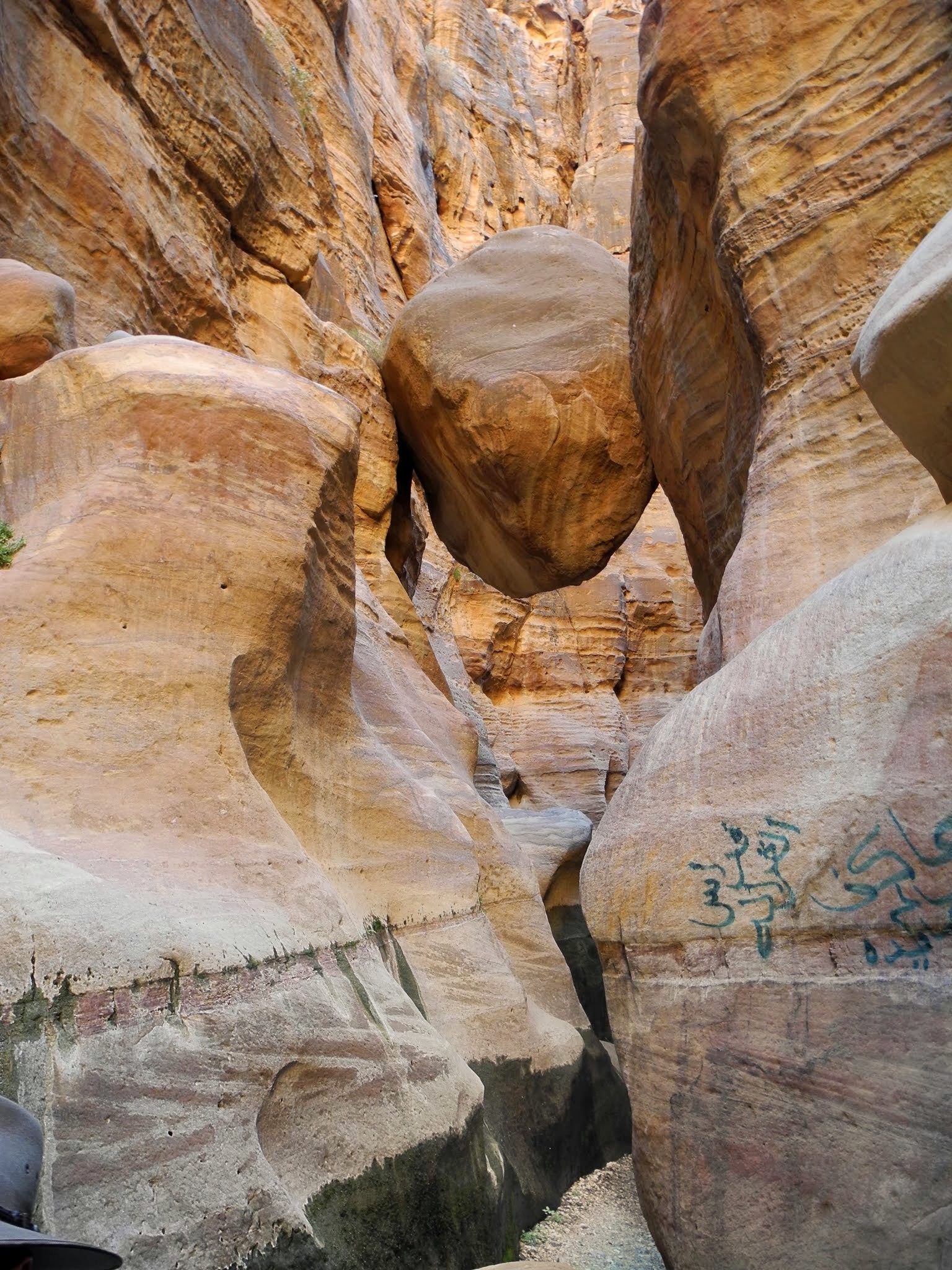 Narrow rock passage along the Wadi Ghuweir trail to Feynan.