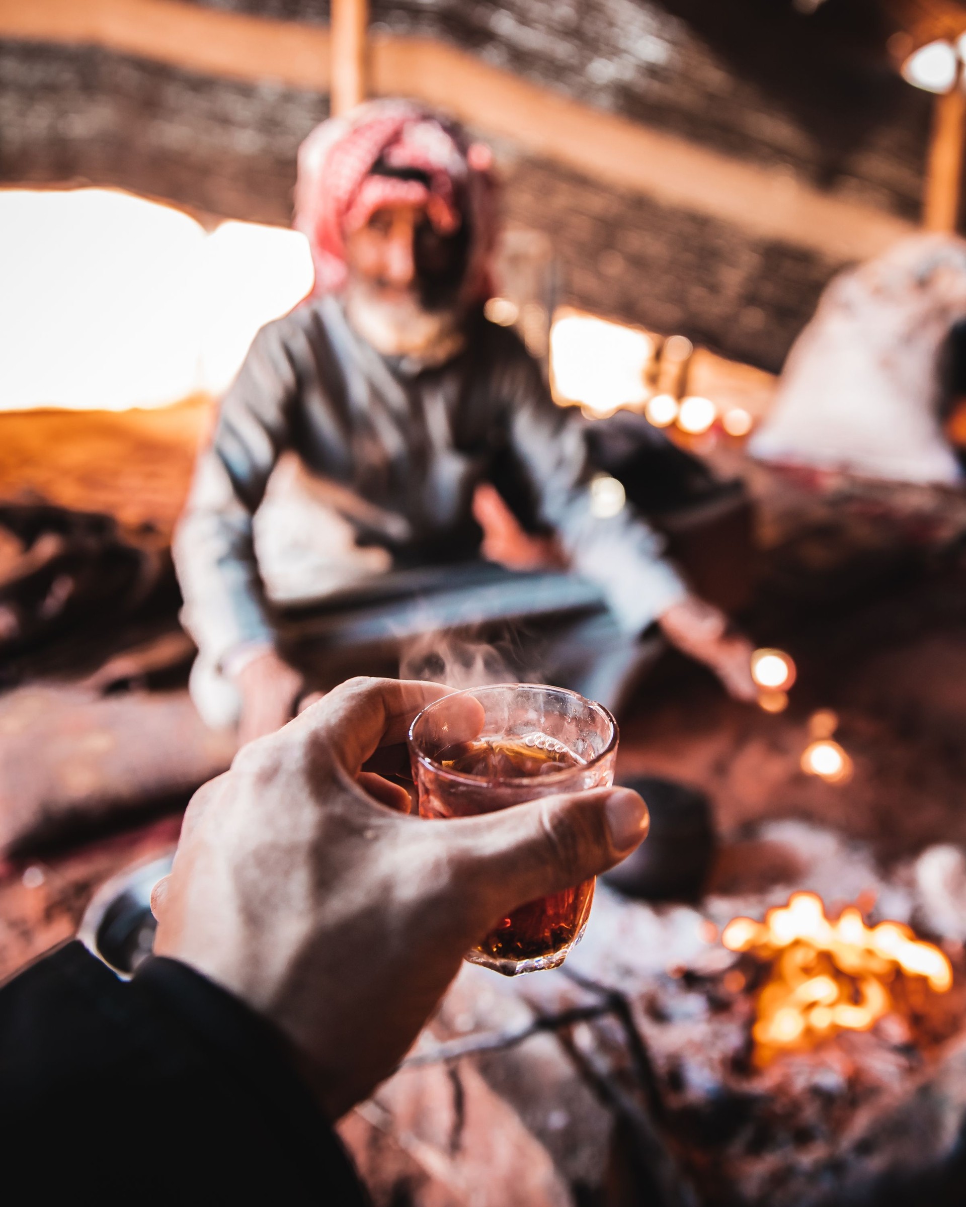 A glass of hot tea offered inside a Bedouin tent in Jordan.