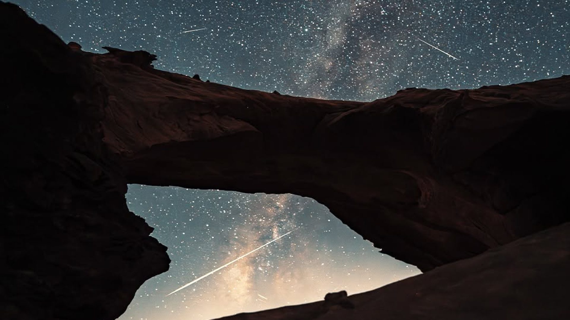 Milky Way above a natural rock bridge in Wadi Rum desert, Jordan