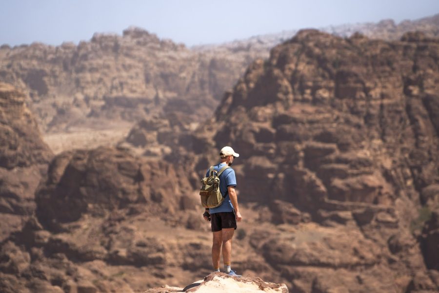Traveler overlooking the sandstone mountains of Petra in Jordan
