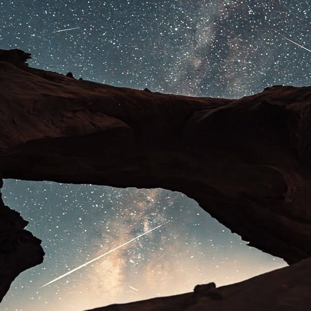 Natural rock arch under the Milky Way night sky in Wadi Rum, Jordan