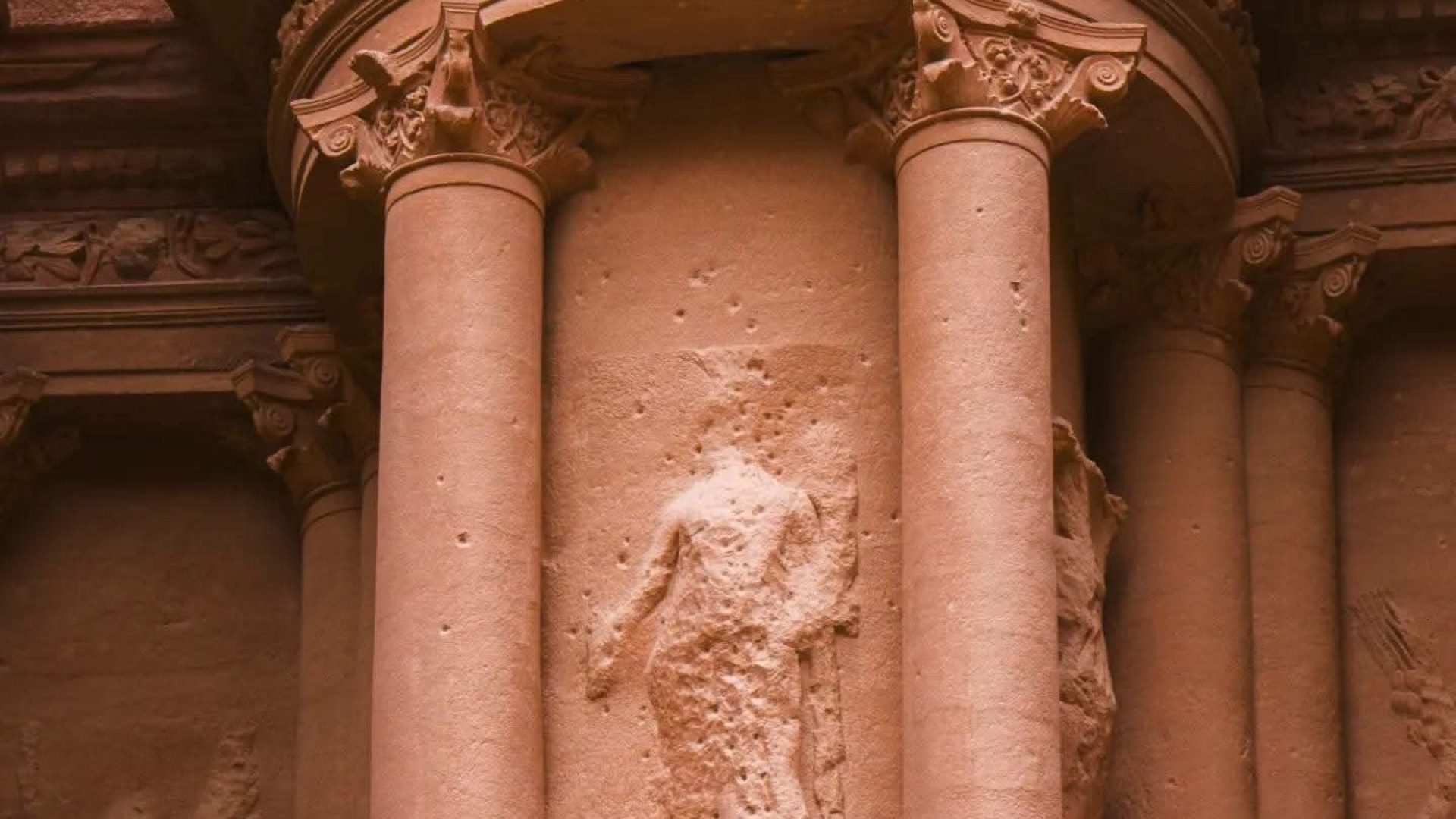 Close-up architectural detail of Al-Khazneh (The Treasury) in Petra, Jordan, showing the ornate Nabataean columns, tholos and ancient rock-carved facade