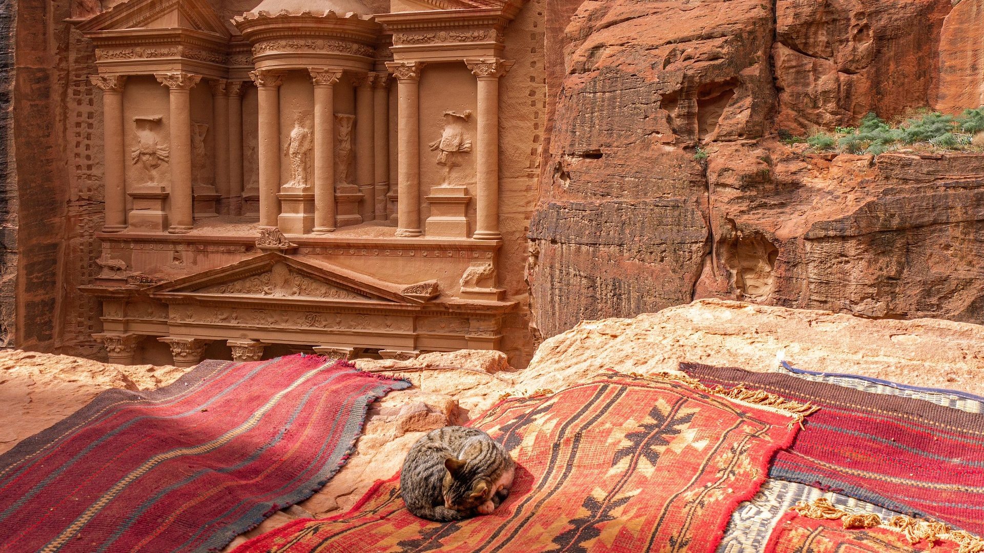 The Treasury of Petra with traditional Bedouin rugs overlooking the ancient rock-carved monument in Jordan
