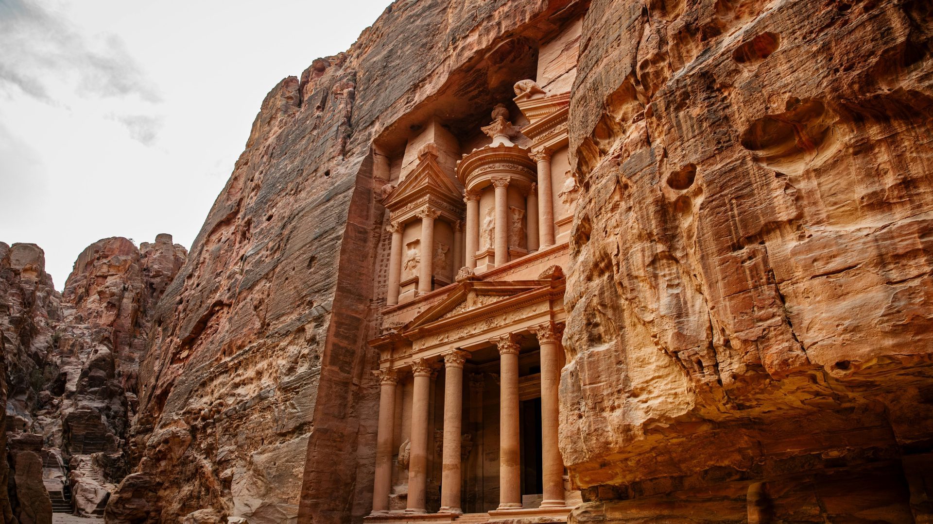 Al-Khazneh Treasury carved into sandstone cliffs in Petra Jordan
