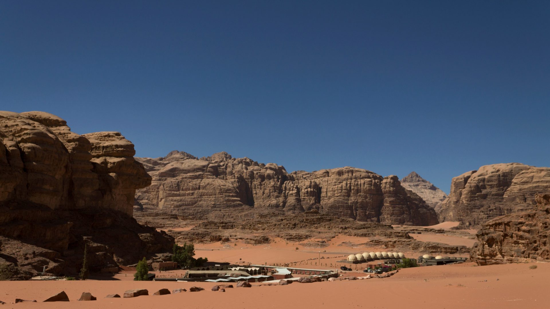 Desert camp beneath sandstone mountains in Wadi Rum Jordan