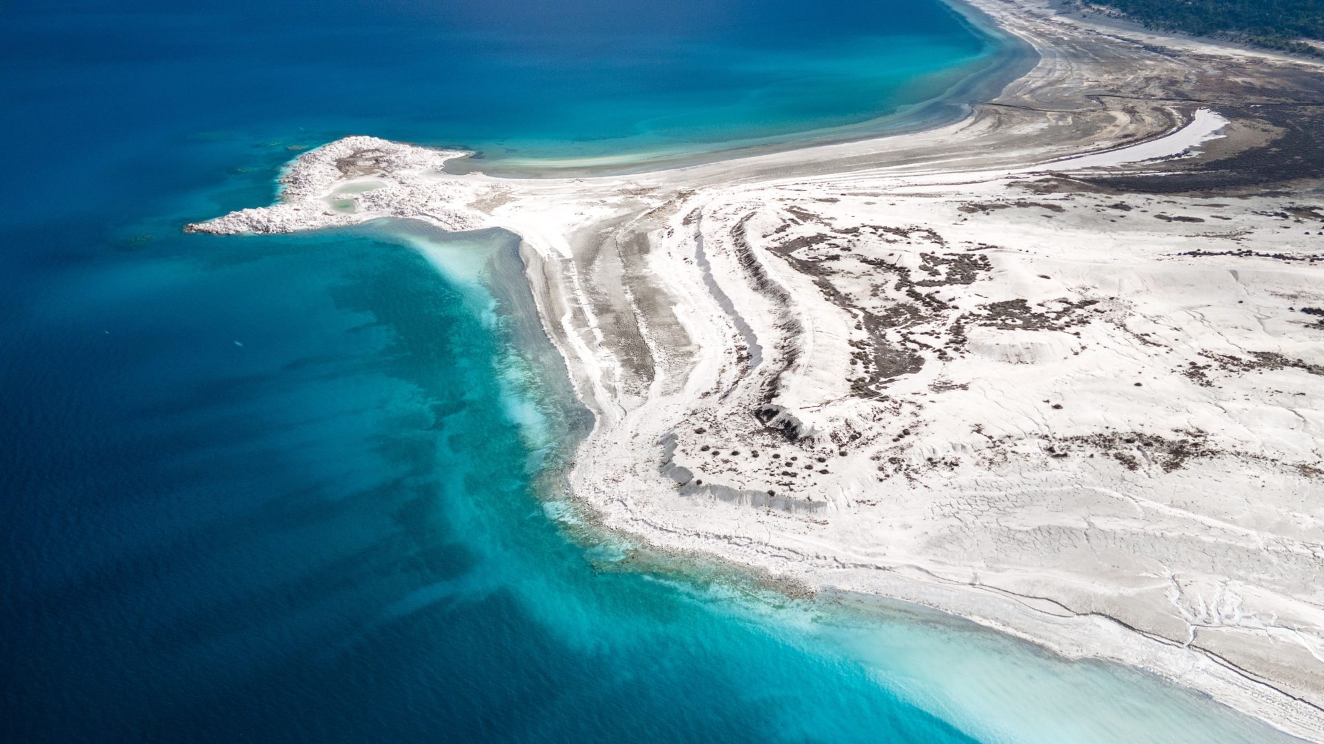 Aerial view of white salt formations along the Dead Sea Jordan