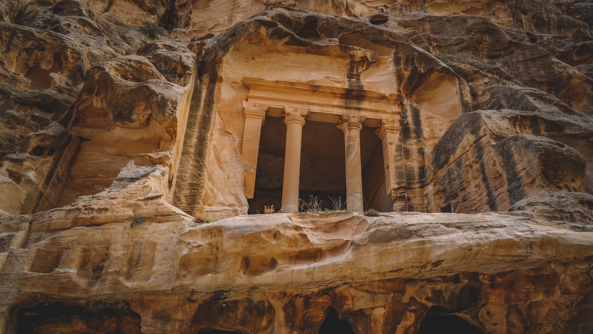 Ancient Nabataean rock-cut facade and columns in Petra Jordan
