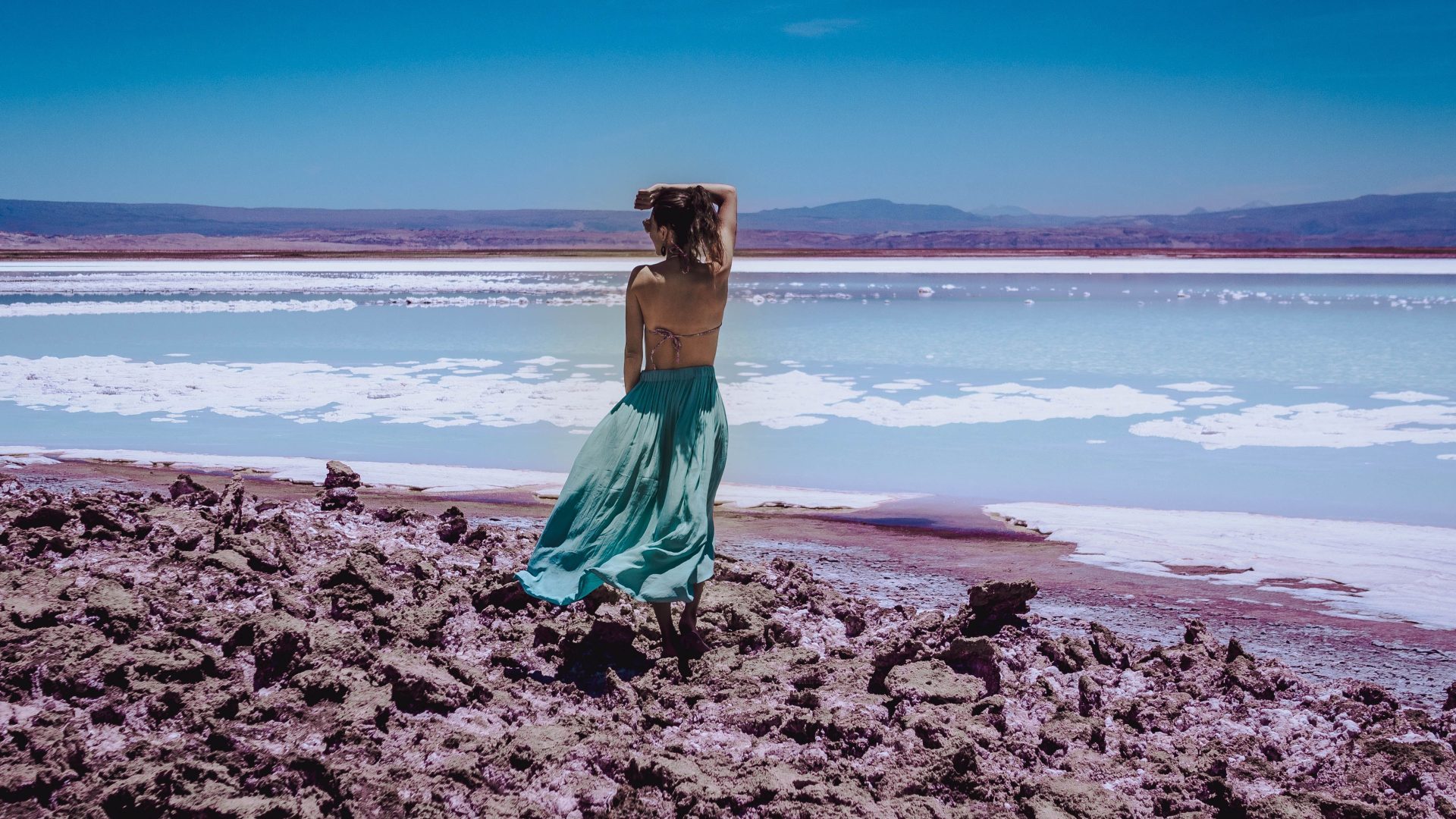 Traveler enjoying the salt shoreline of the Dead Sea Jordan