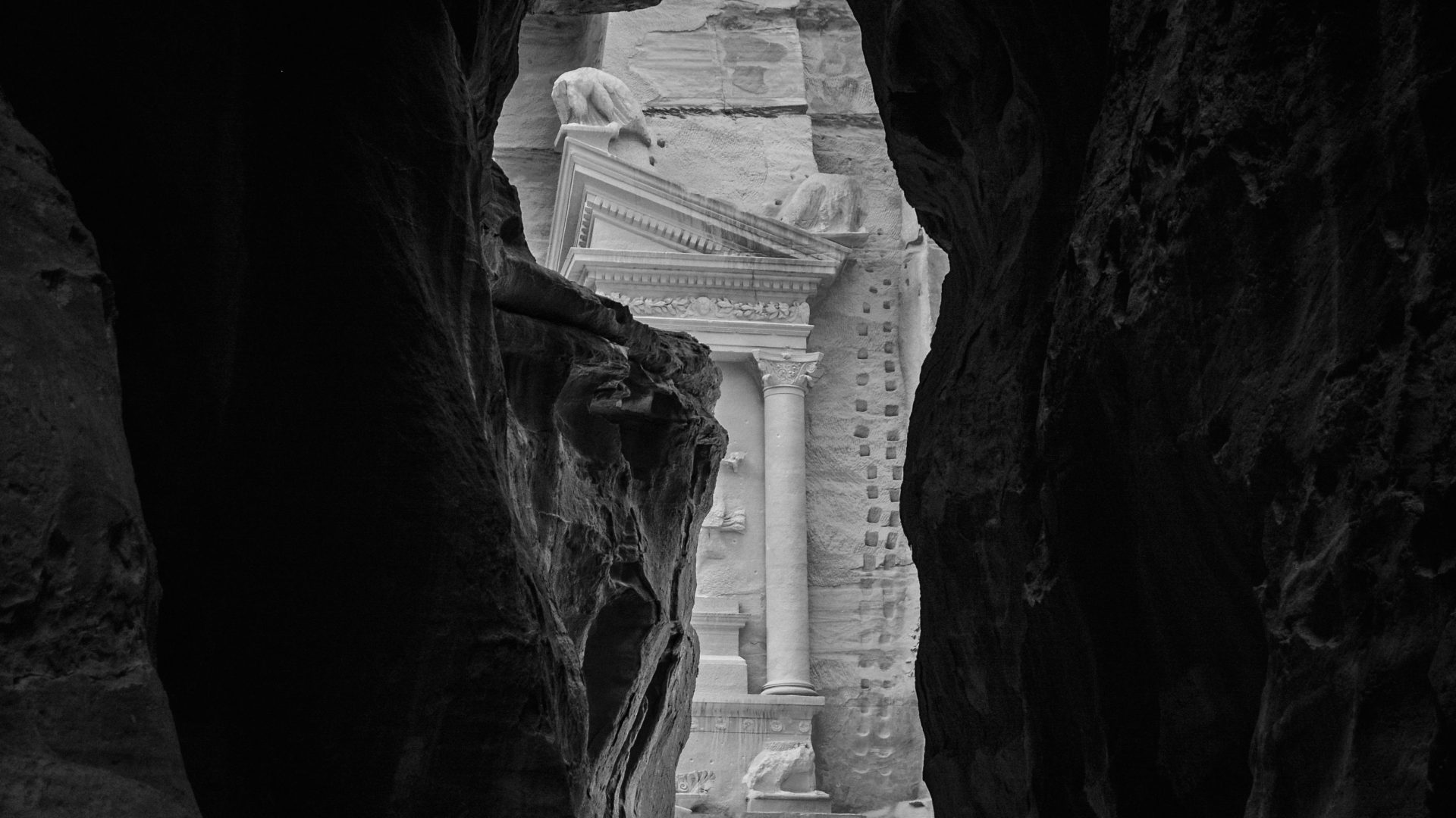 The Treasury of Petra (Al-Khazneh) viewed through the narrow Siq canyon, Petra, Jordan