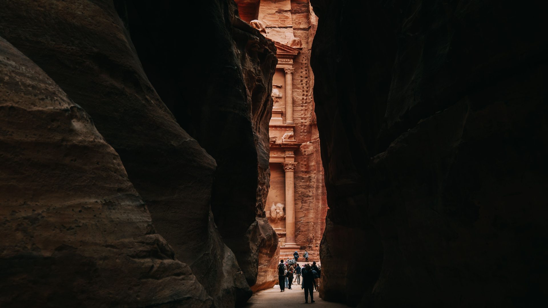 The Treasury of Petra (Al-Khazneh) emerging through the narrow Siq canyon, Petra, Jordan