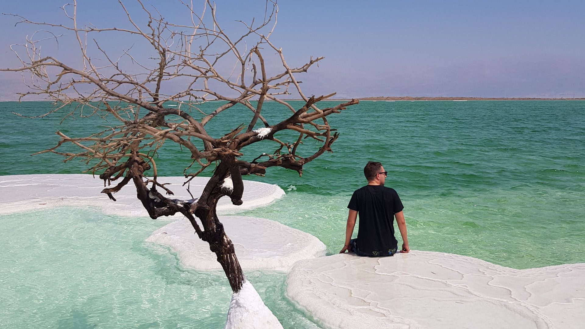 Traveler enjoying the turquoise waters of the Dead Sea Jordan