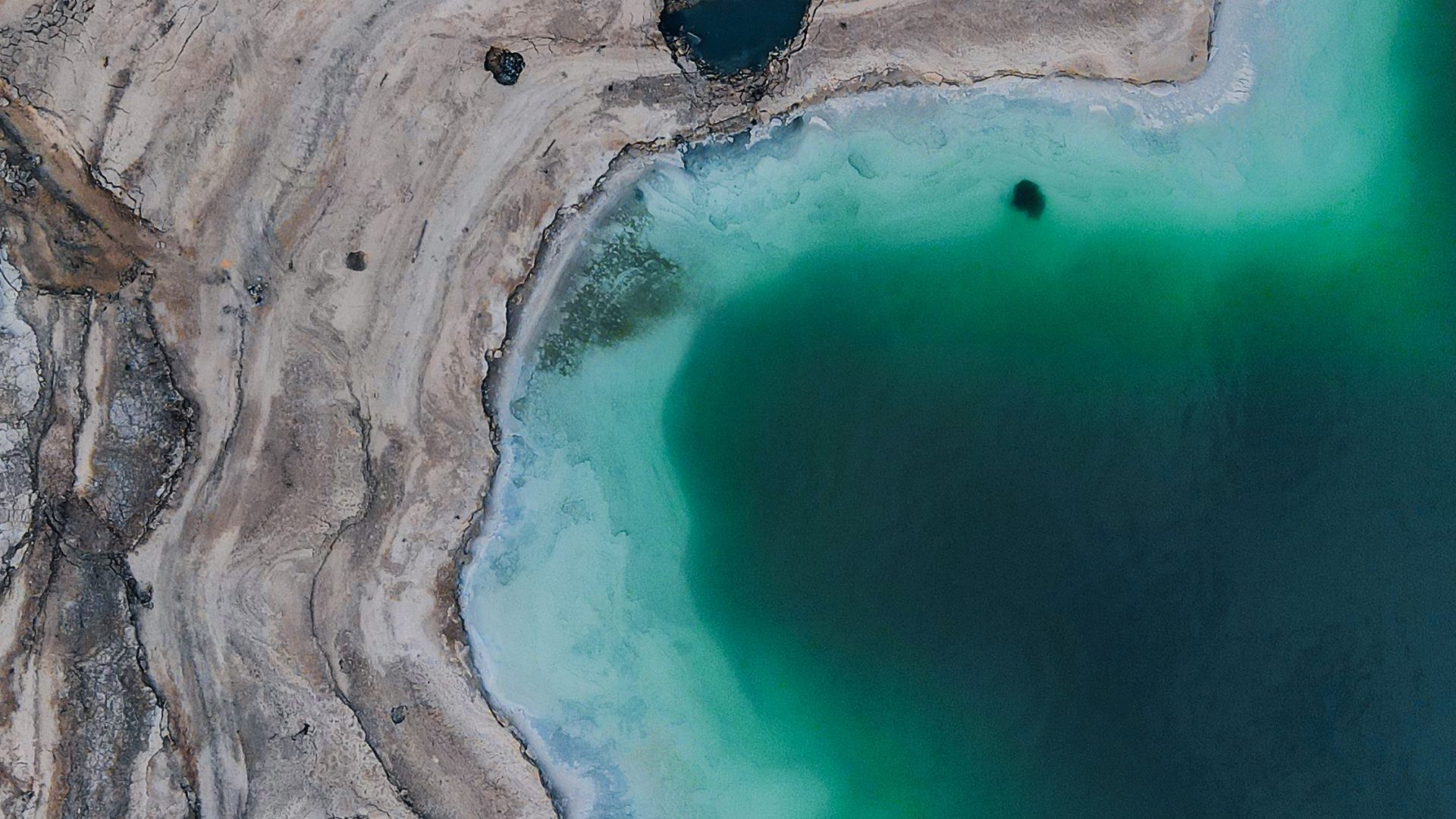 Aerial view of turquoise water and shoreline at the Dead Sea Jordan