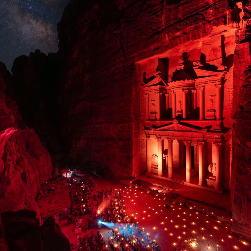 Petra by Night with the illuminated Treasury, candlelit pathway, and starry sky in Jordan