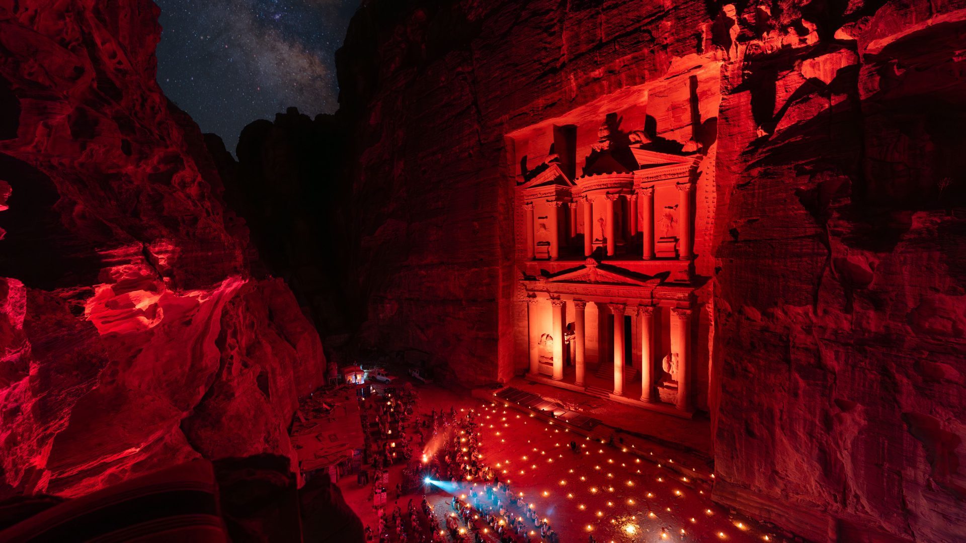 Petra by Night with the illuminated Treasury, candlelit pathway, and starry sky in Jordan